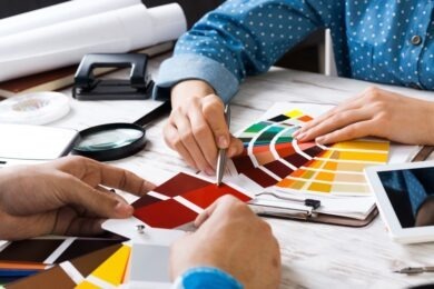 designer and client meeting in office choosing colors from color palette