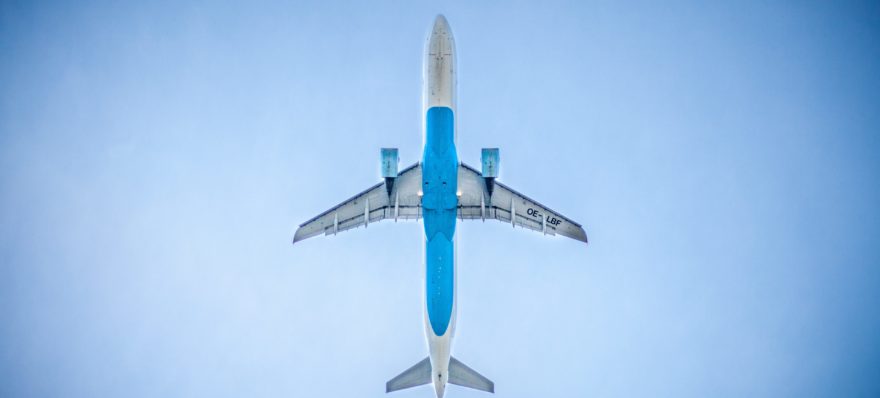 An airplane from below. Airlines continue to require Covid testing