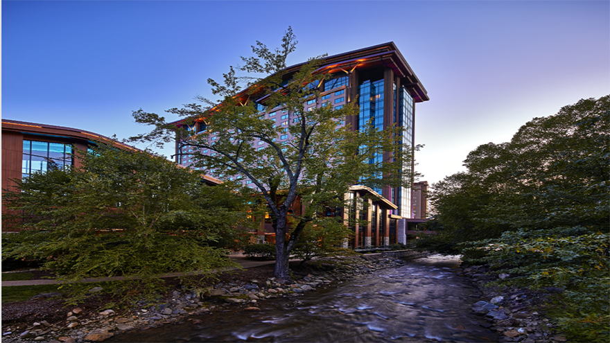 The outside of Harrah's Cherokee, a tall glass and wood building