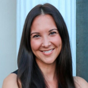 A portrait of Carly Skinner. She is a woman with long black hair and a black blouse