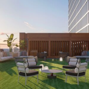 A render of an outdoor lounge at Conrad Nashville. Chairs are arranged around a table on turf