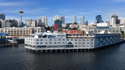 A large white building on a river in Seattle
