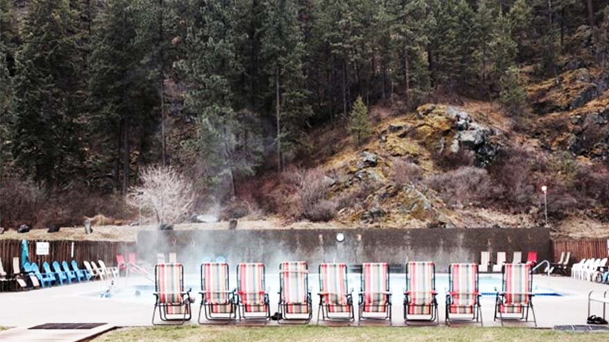 An artificial hot spring at Paradise Montana surrounded by lounge chairs