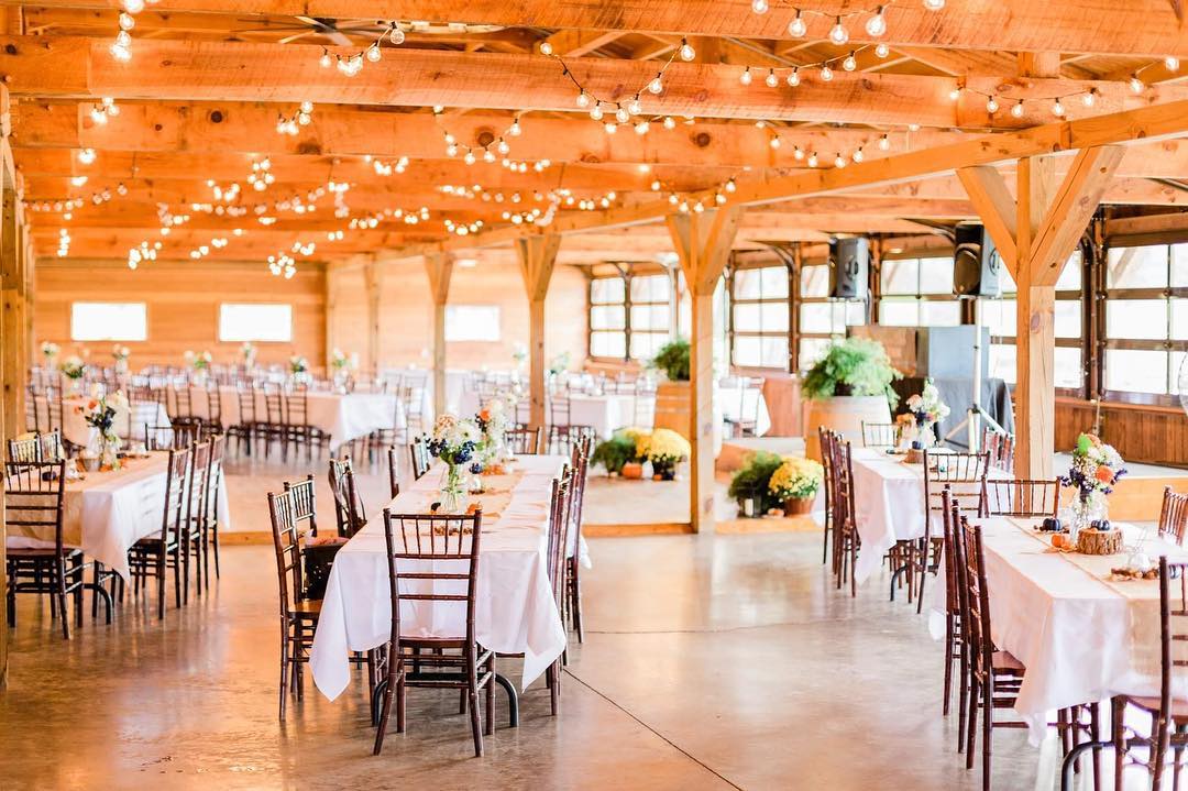A large dining venue with exposed wooden beams and fairy lights.