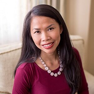 A portrait of Sheila Buciuman. She is an Asian woman with long black hair and a magenta blouse