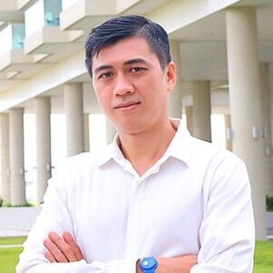 A portrait of Son Hoang Le. He is an Asian man with combed black hair in a white collared shirt