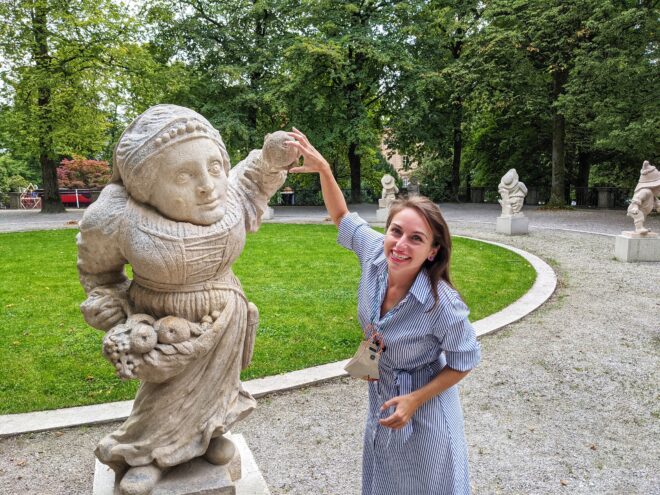 Ashley Lawson touching the hand of a gnome statue in Austria
