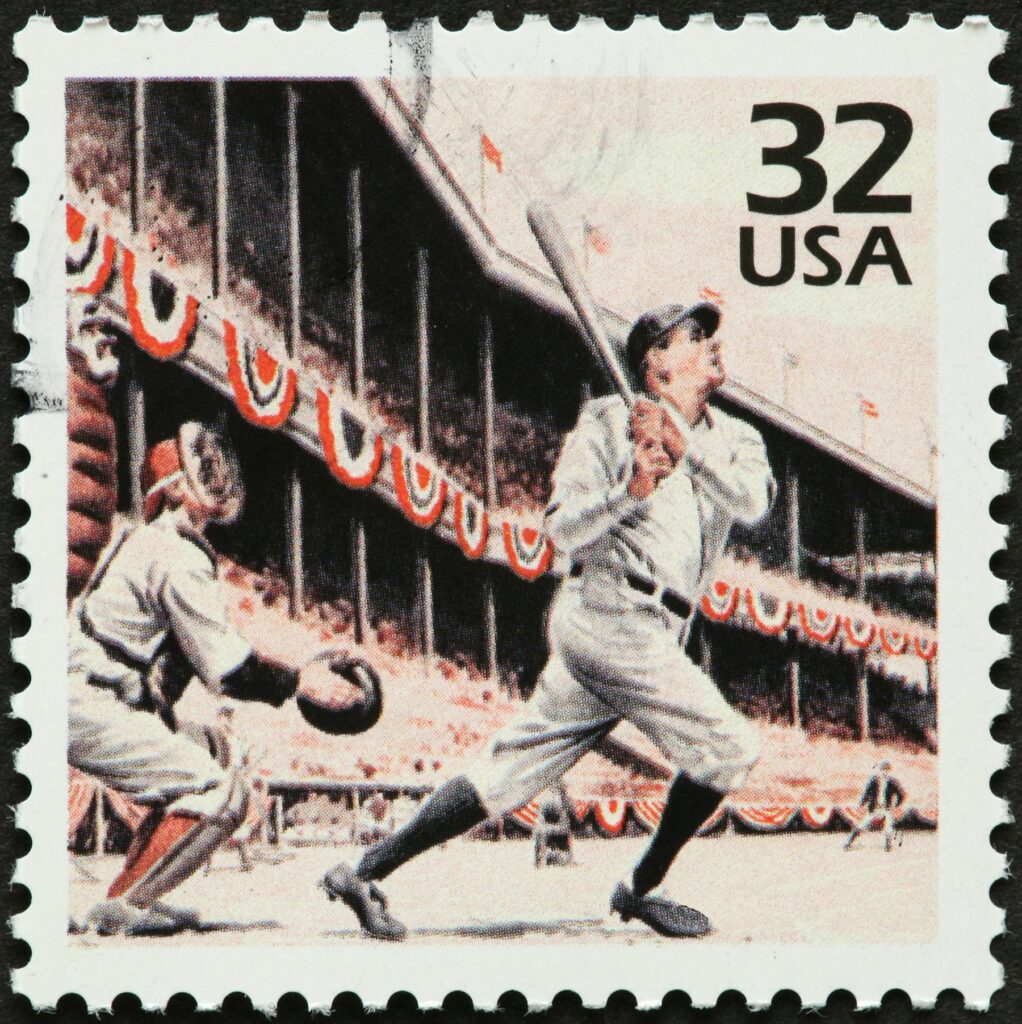 A 32 cent US stamp showing a batter swinging a baseball bat in front of a catcher