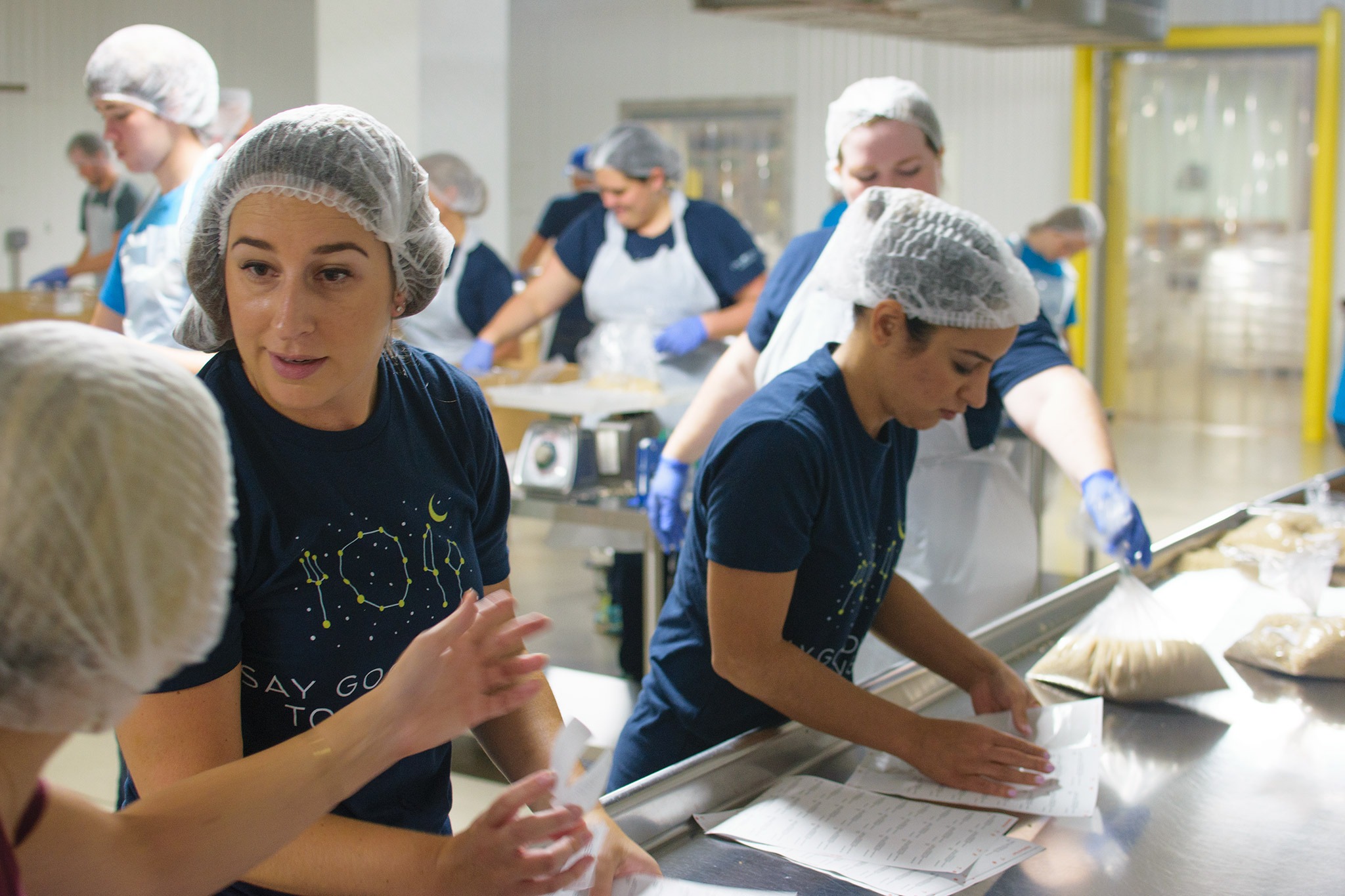 Volunteers for Omni Hotels & Resorts' "Say Goodnight to Hunger" program preparing meals.