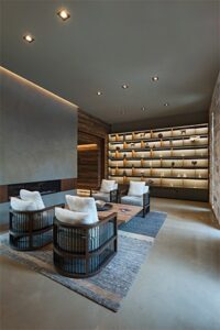 The spa lobby of Miraval Life in Balance. Four black chairs are arranged around a small wooden table