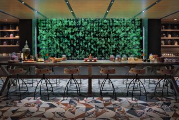 A table in Six Senses Kaplankaya. The wall behind the table is lit up green