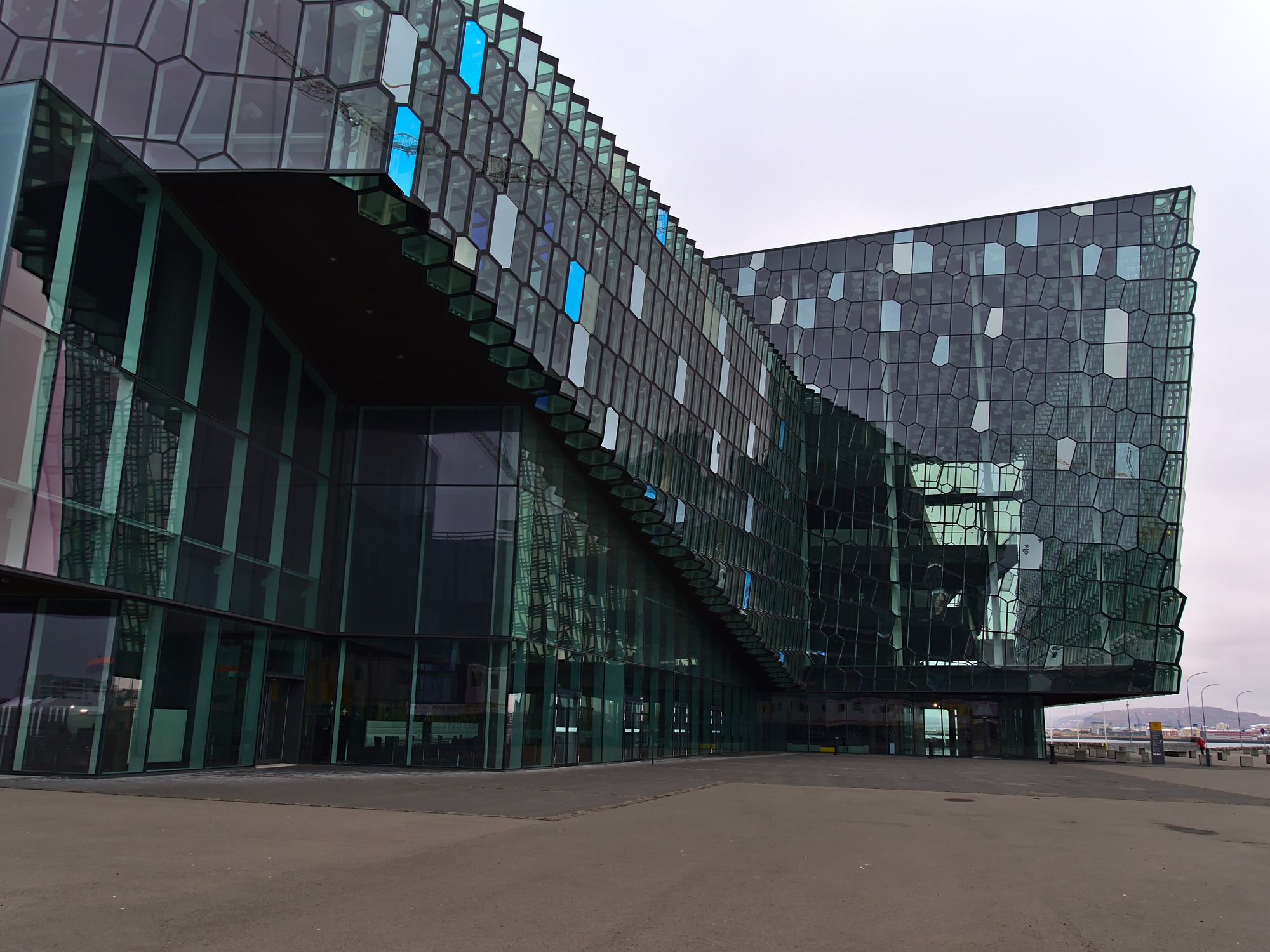 The Harpa Reykjavik Concert Hall and Conference Center in Iceland. It is a modern glass building with irregularly shaped windows.