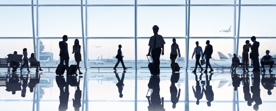 Silhouetted people in an airport terminal. Airlines recently lifted the mask mandate.