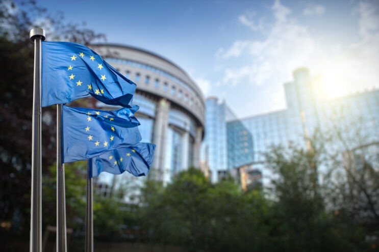 The parliament building in Brussels with the European Union flag.