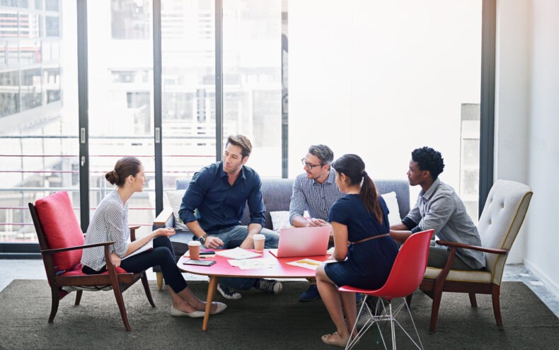 Several people gathered around a table for a meeting.