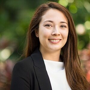 A portrait of Cohco Harbour. She is a young Asian woman with long brown hair.