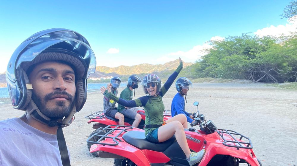 A group of coworkers on a teambuilding excursion. They are riding in 4x4s and wearing helmets.