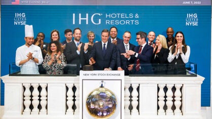 IHG CEO Keith Barr rings the bell for the New York Stock Exchange surrounded by colleagues.