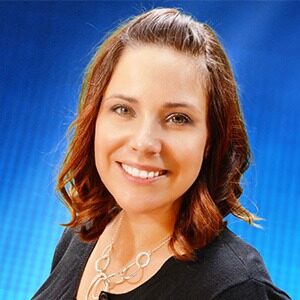 A portrait of Stacy Daeffler. She is a young white woman with a black blouse and a silver necklace.