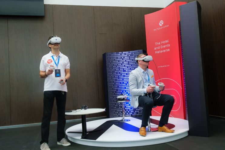 Two RendezVerse employees demonstrate one of their digital hotel replicas.