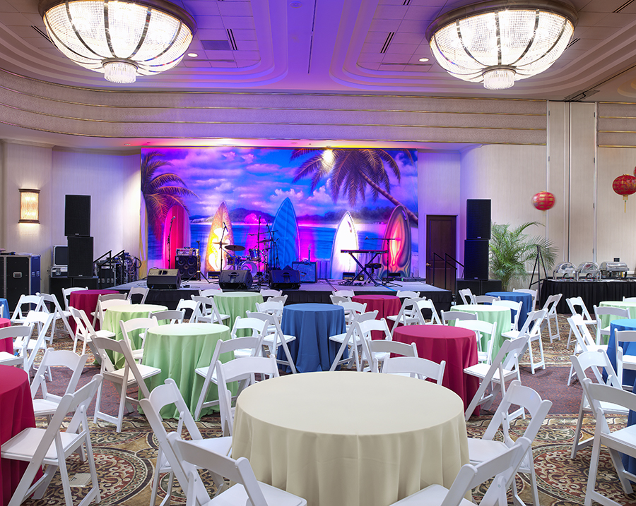 The Mohawk Room at Turning Stone Resort & Casino. Purple lights color a stage in front of round tables.