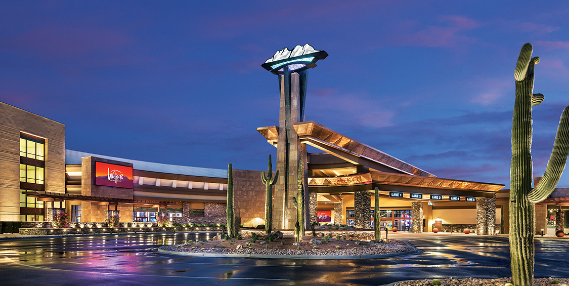 The exterior of We-Ko-Pa Resort & Conference Center. It is late in the evening, and the building is lit up.