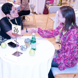 Two women talking at a small round table at the Smart Meetings Mid-Atlantic Conference.