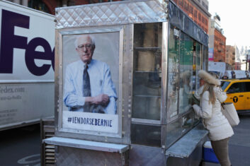 A poster on the end of a truck with a picture of Bernie Sanders. There is text reading #I endorse Bernie.