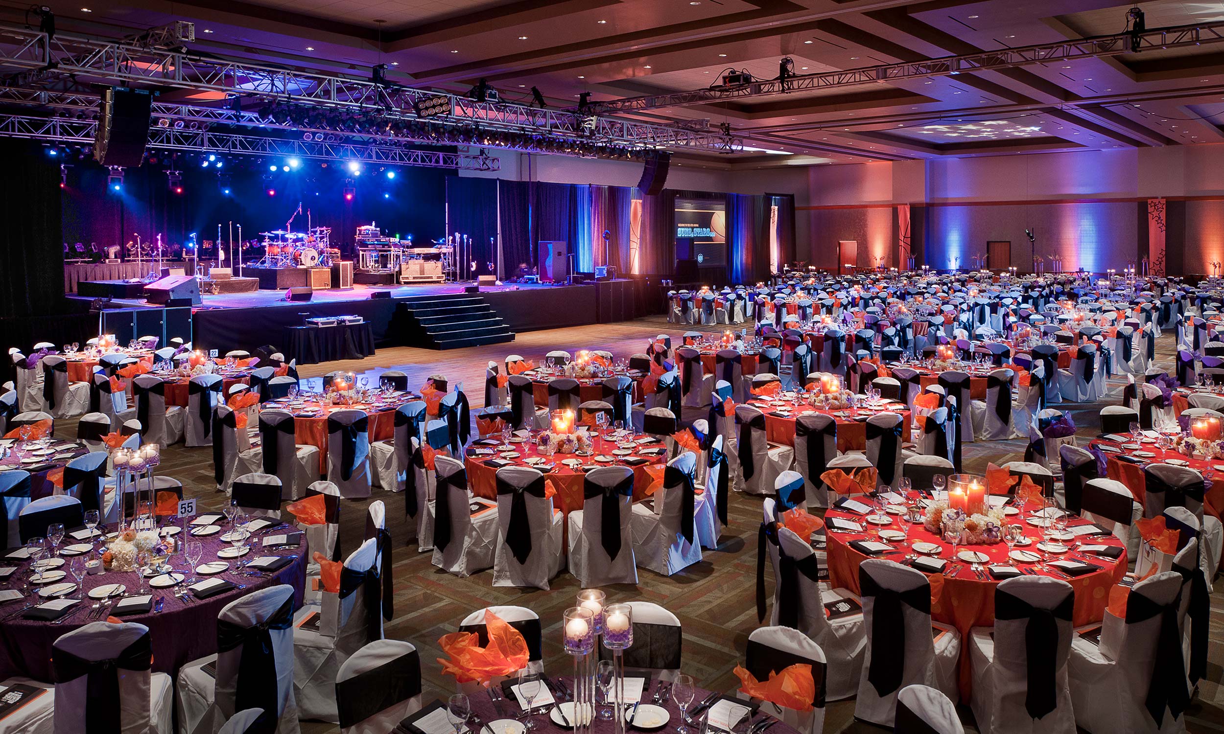 The Salt River Grand Ballroom at Talking Stick Resort. Round tables are arranged in front of a large stage.