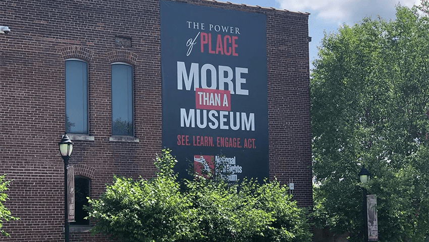 The exterior of the National Civil Rights Museum. A banner reads, "The Power of Place. More than a museum. See, learn, engage, act."