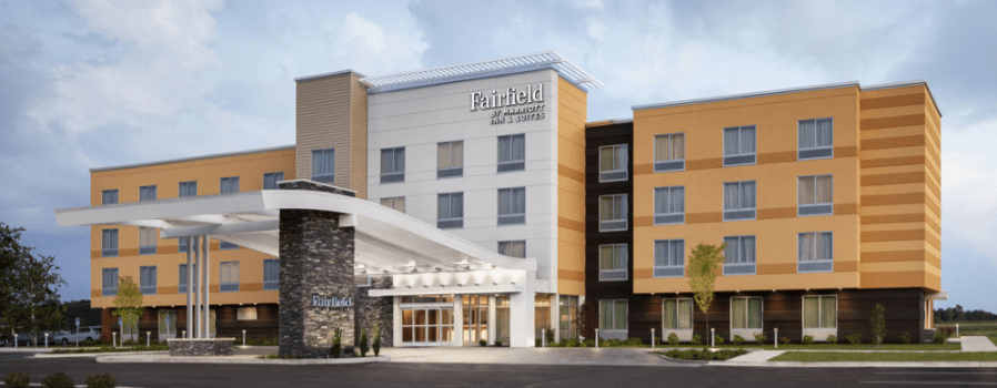 The Fairfield Inn & Suites, a wide hotel with orange and white stucco.