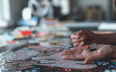 A person arranging a mosaic on the island of Mykonos, from the Idyllic Aegean cruise