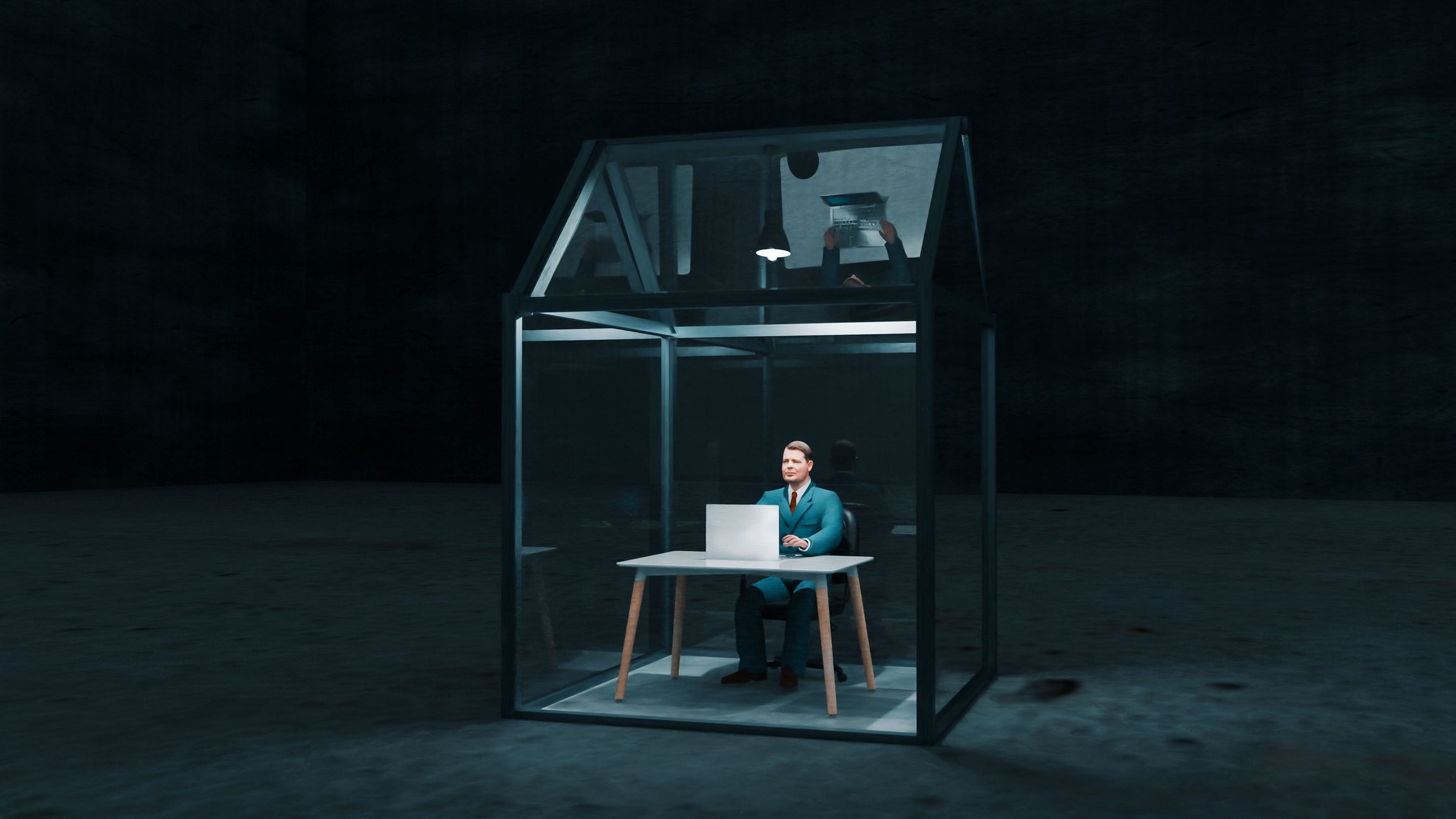 businessman working on a laptop sequestered in a glass box