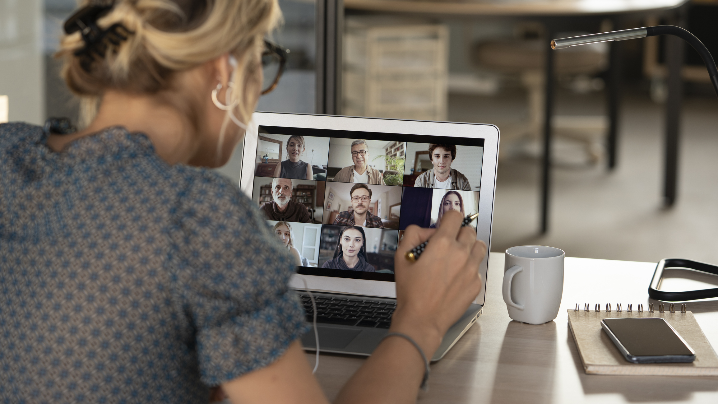 Lady talking and watching a video conference call 