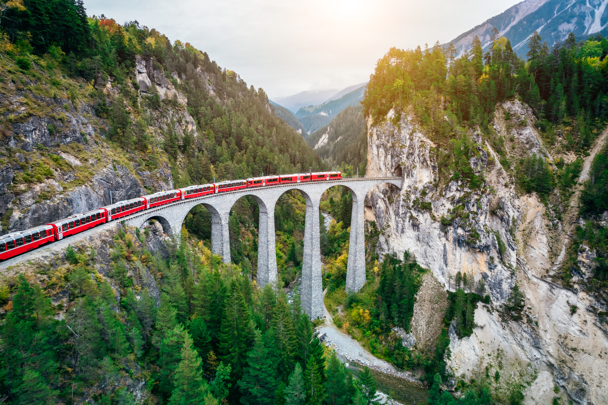 Train crossing bridge on a mountain