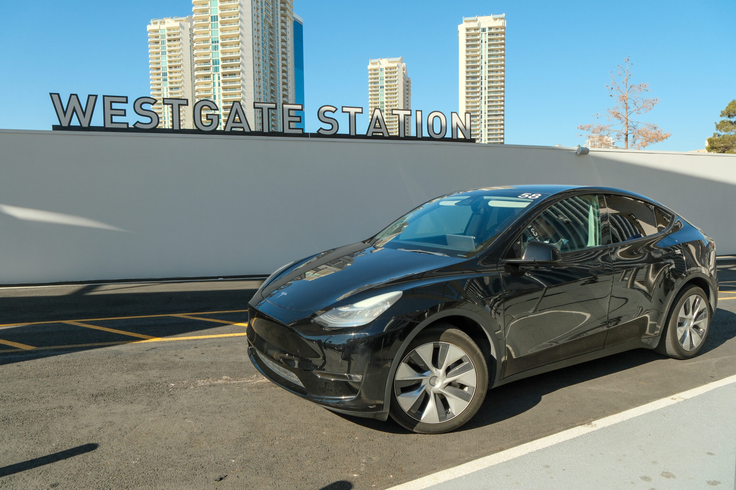 Black Tesla next to "Westgate Station" sign