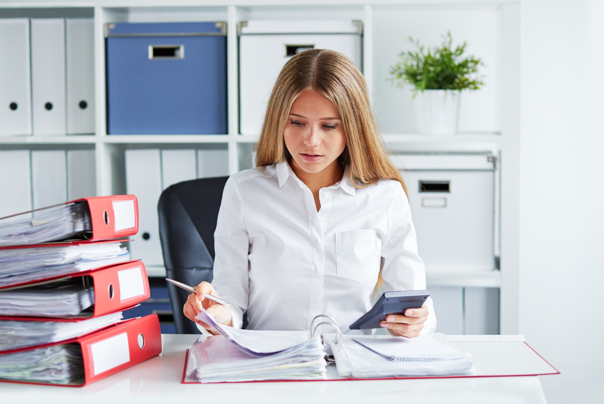 Business woman calculating taxes