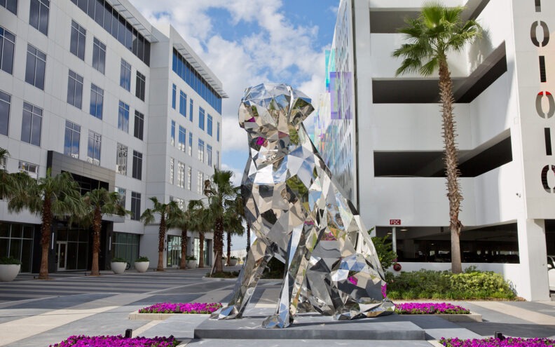 large silver dog sculpture outside of lake nona wave hotel in florida