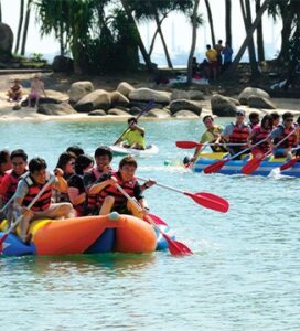 people rafting as a team-building exercise at Palawan Beach in Singapore