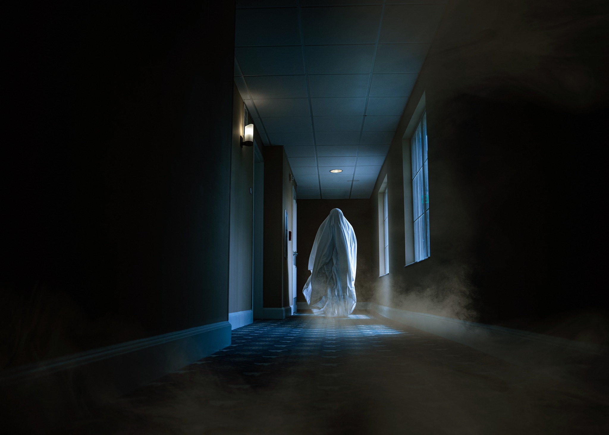 ghost moving in a hotel corridor