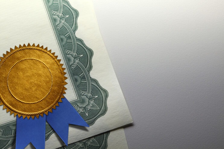 Gold Seal With Blue Ribbon On A Certificate