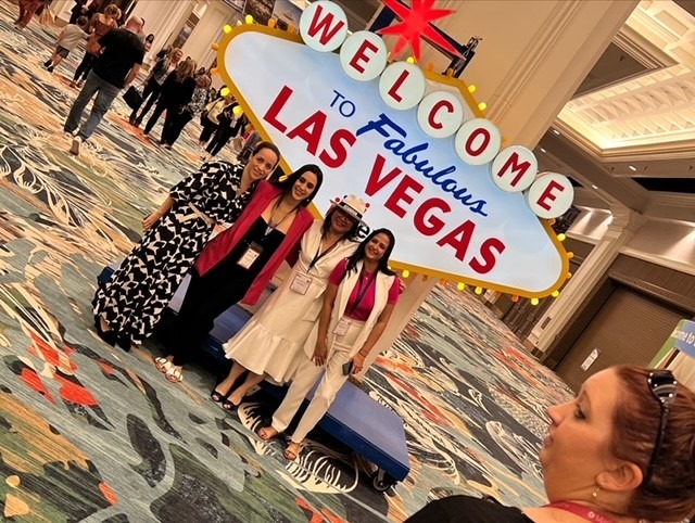 Posing in front of Las Vegas sign at IMEX America