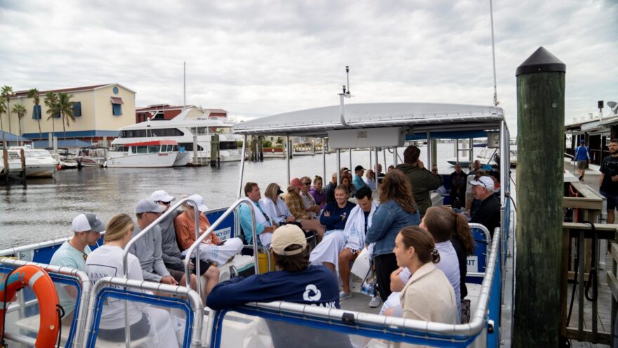 attendees smiling and laughing on a boat in naples, florida