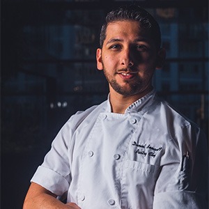 daniel benavidez in kitchen wearing chef shirt