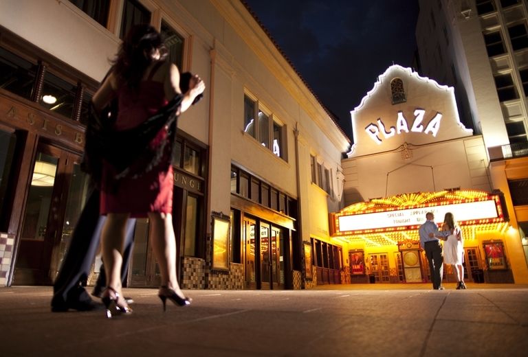 couple walking behind another couple at plaza theatre in el paso