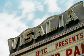 A neon sign and marquee for the Visalia Theater