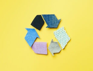 multicolored recycle symbol on yellow background
