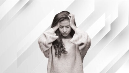 black and white image of worried woman grabbing her head