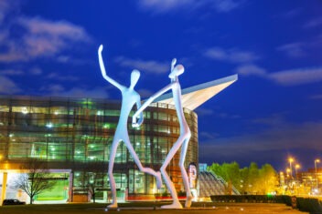 The Dancers public sculpture at the Denver Performing Arts Complex at night time in Denver, Colorado.