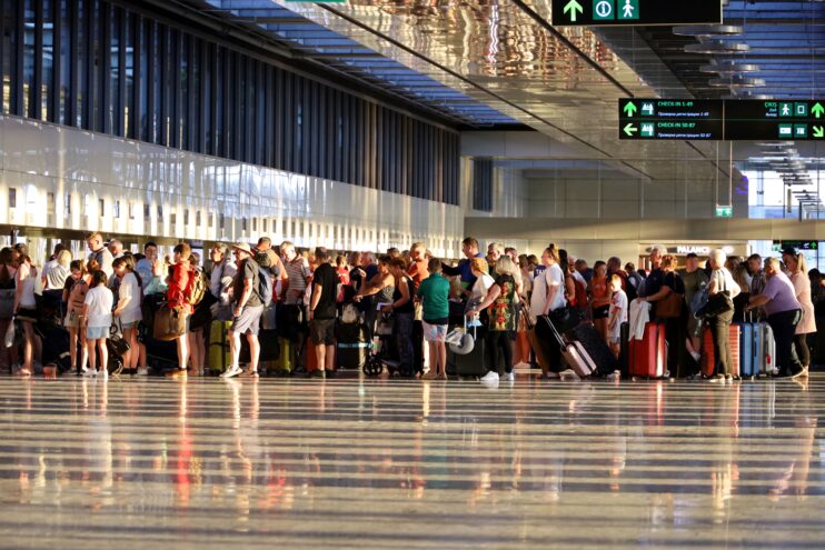 people waiting in line at airport in dalaman, turkey